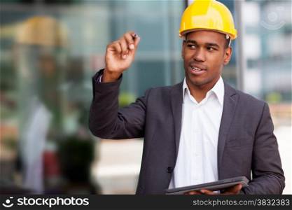 Photo of african construction engineer drawing with a digital pen