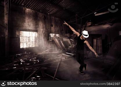 Photo of african guy dancing in ruins
