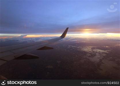 photo of aircraft wing flying over beautiful clouds