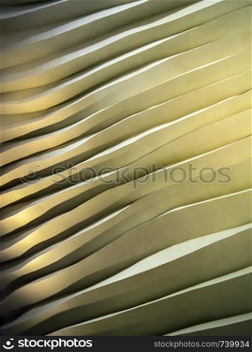 Photo of an abstract wall of uneven waves with shadows and highlights.