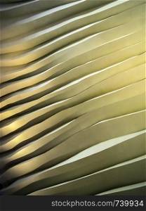 Photo of an abstract wall of uneven waves with shadows and highlights.