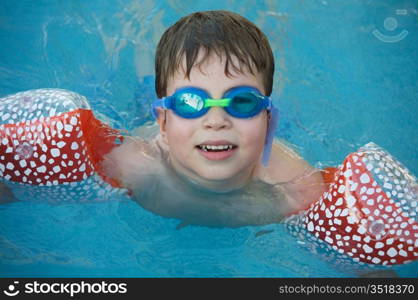 photo of an adorable boy learning to swim