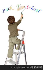 photo of an adorable boy painting the text back to school a over white background