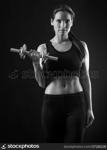 Photo of an attractive female doing a dumbbell curl black and white version.&#xA;