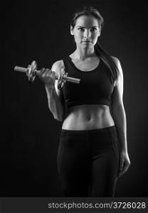Photo of an attractive female doing a dumbbell curl black and white version.&#xA;