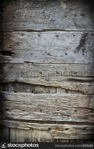 Photo of an old worn wooden door in Italy.