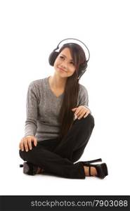 Photo of asian woman listening music with headphones over white isolated background