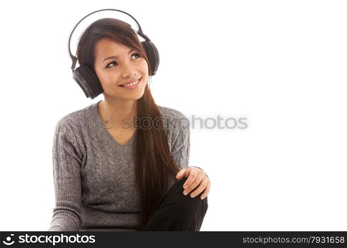 Photo of asian woman listening music with headphones over white isolated background