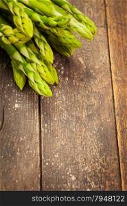Photo of asparagus over wooden table