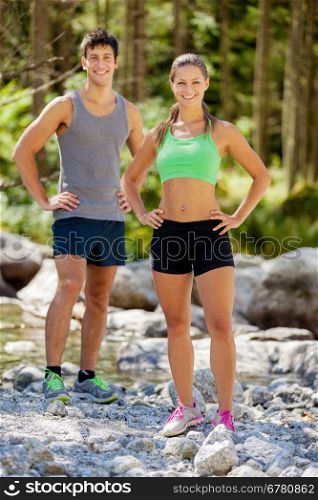 Photo of athletic couple in the mountains with running outfit