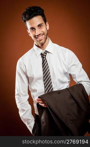 photo of attractive businessman with jacket in his hands