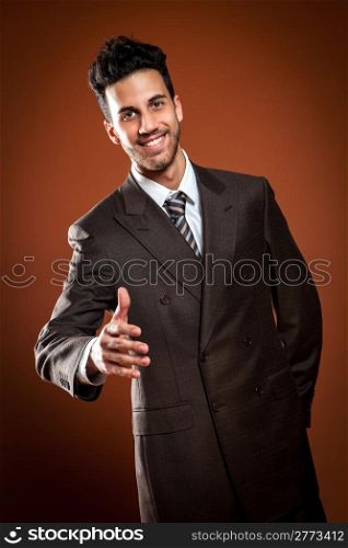 photo of attractive smiling businessman offering handshake