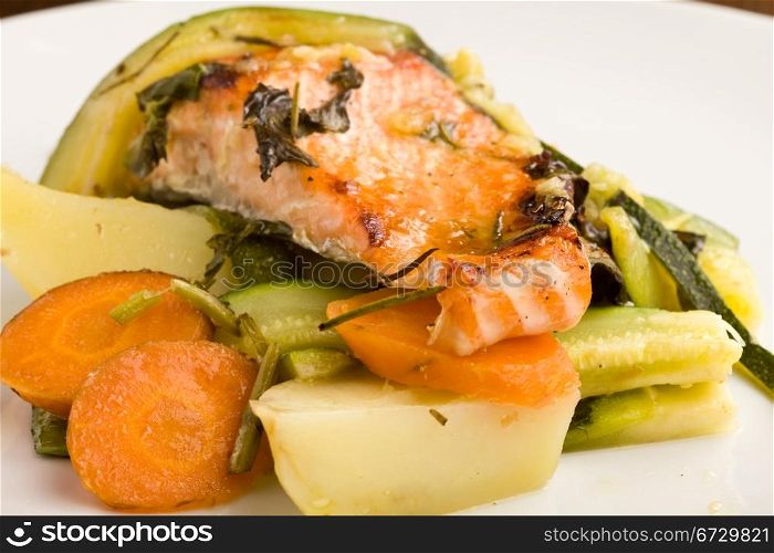 photo of baked salmon with vegetables on white plate
