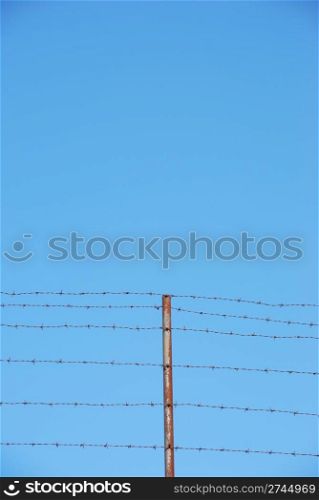photo of barbed wire with plenty blue sky space
