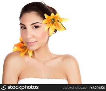 Photo of beautiful arabic woman with yellow lily flower in head, portrait of cute brunette girl wearing bath towel isolated on white background, natural facial cosmetics, beauty and spa concept