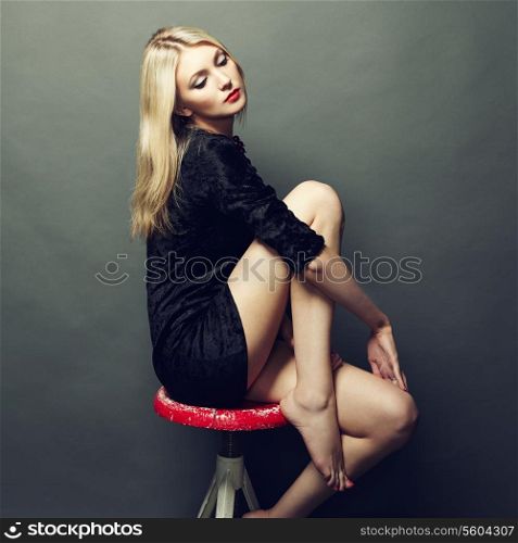Photo of beautiful blonde woman in black dress. Fashion photo