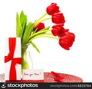 Photo of beautiful red tulips bouquet in vase, white giftbox with ribbon, greeting card, love you mom, happy mothers day, flowers bunch as present, romantic still life, merry holiday, love concept