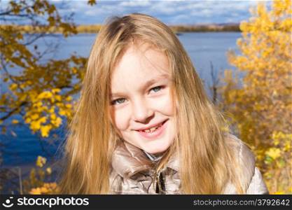 Photo of beautiful smiling girl in autumn
