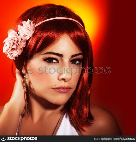 Photo of beautiful woman with red hair and stylish makeup isolated on red background, sexy woman wearing fashionable pink accessories on head, Valentine day, beauty and passion concept&#xA;