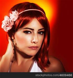 Photo of beautiful woman with red hair and stylish makeup isolated on red background, sexy woman wearing fashionable pink accessories on head, Valentine day, beauty and passion concept&#xA;