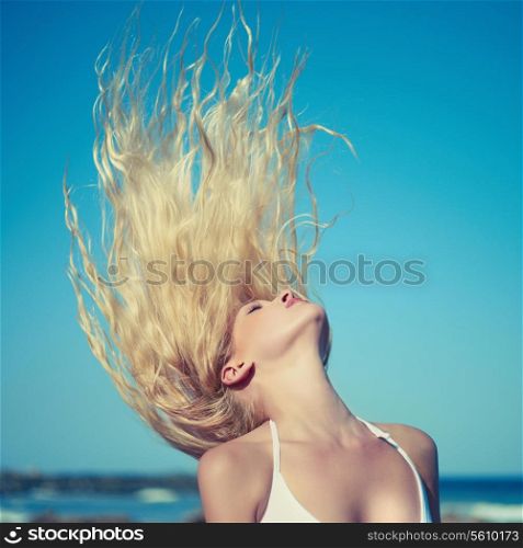 Photo of beautiful young blonde at blue sea