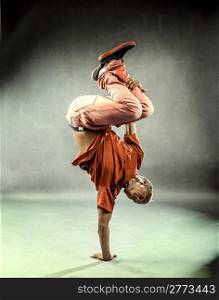 photo of boy who is posing his dance movements in front of the camera