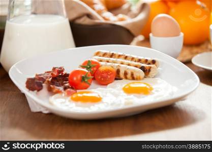 Photo of breakfast table with a plate of delicious english breakfast