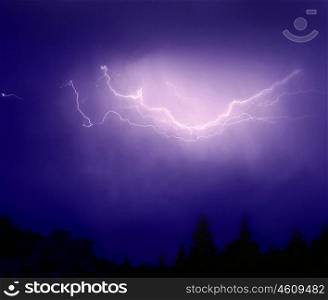 Photo of bright lightning over dark blue sky, image of zipper flash above forest, picture of dangerous thunderstorm, abstract background, autumn weather&#xA;