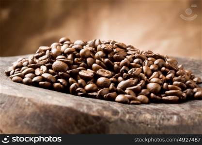 photo of brown delicious roasted coffee beans on wooden table