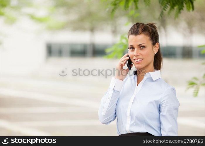 Photo of brunette businesswoman who is phoning
