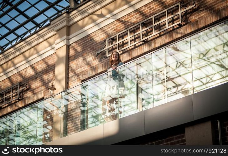 Photo of brunette woman at shopping mall with bag