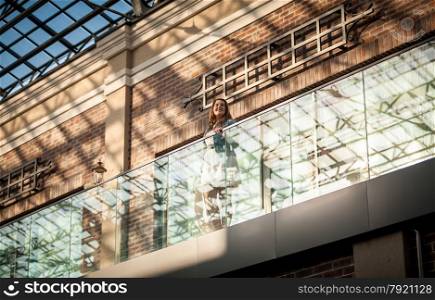 Photo of brunette woman at shopping mall with bag