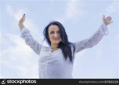 Photo of brunette woman with upward hands