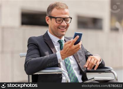 Photo of businessman on wheelchair who is phoning