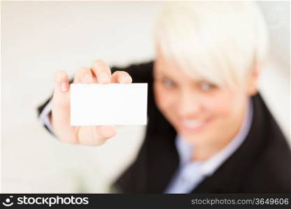 Photo of businesswoman holding business card while smiling