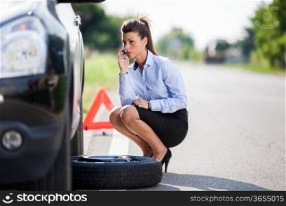 photo of businesswoman with flat tire