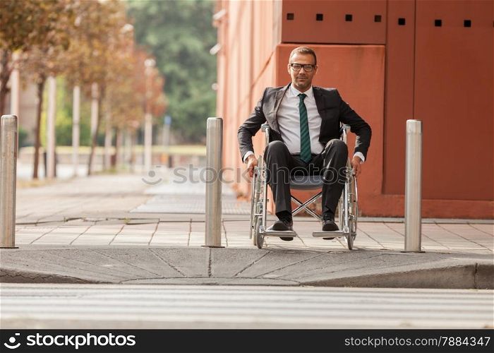Photo of caucasian businessman on wheelchair trying to cross the road