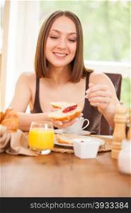 Photo of caucasian woman having breakfast at home