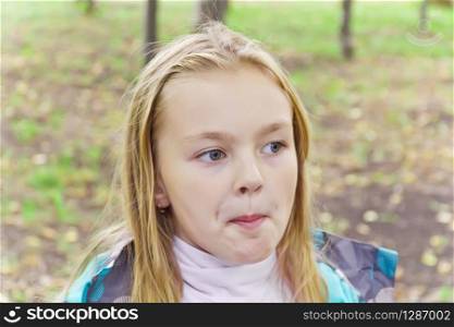 Photo of chewing cute girl with blond hair