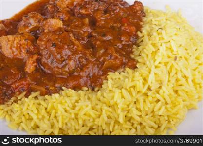 photo of chicken jalfrezi with pilau rice on a plate