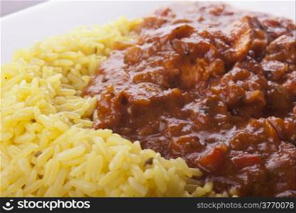photo of chicken jalfrezi with pilau rice on a plate