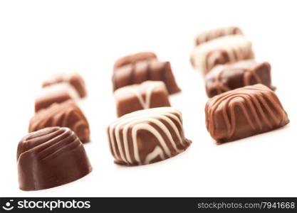 Photo of chocolate pralines over white isolated background
