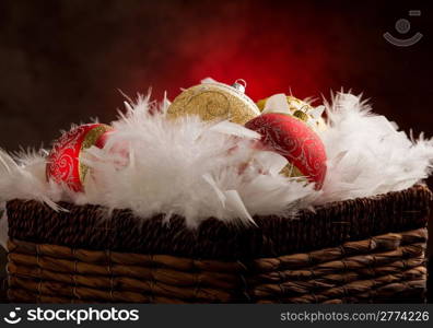 photo of christmas balls inside a feather basket in front of a rural background