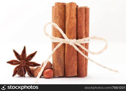 Photo of cinnamon sticks and star anise over white isolated background