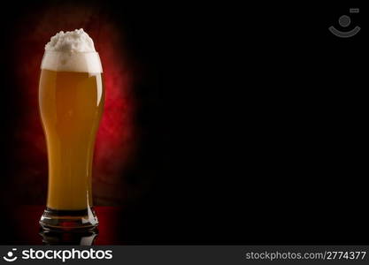 photo of cold delicious beer in front of a rural background