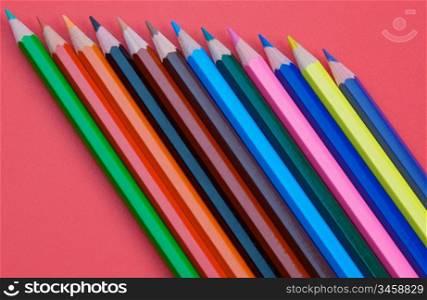 photo of color pencils over a red background