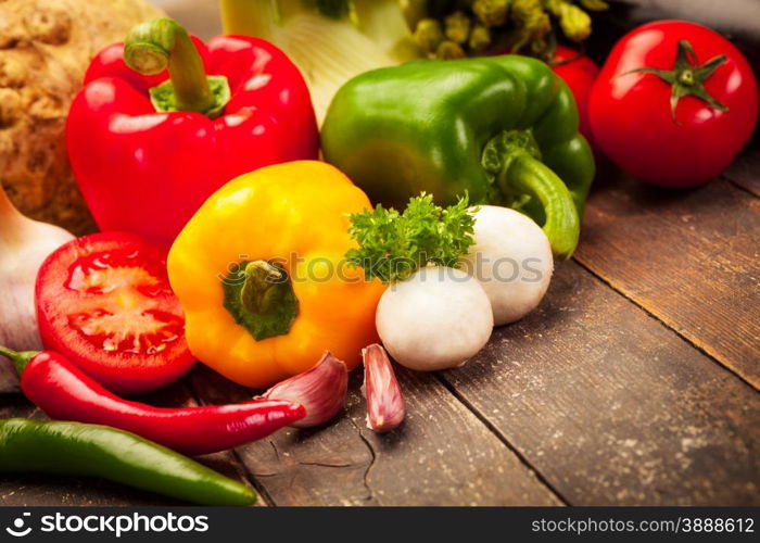 Photo of colorful vegetables over old wooden table