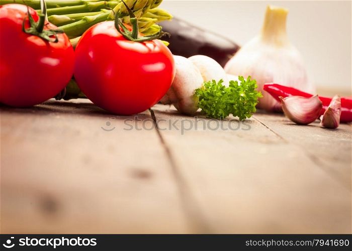 Photo of colorful vegetables over old wooden table