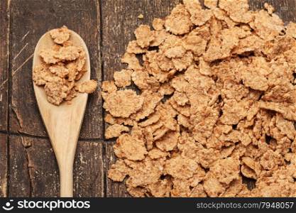 Photo of corn flakes over old wooden table