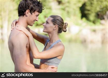Photo of couple in love in front of a lake